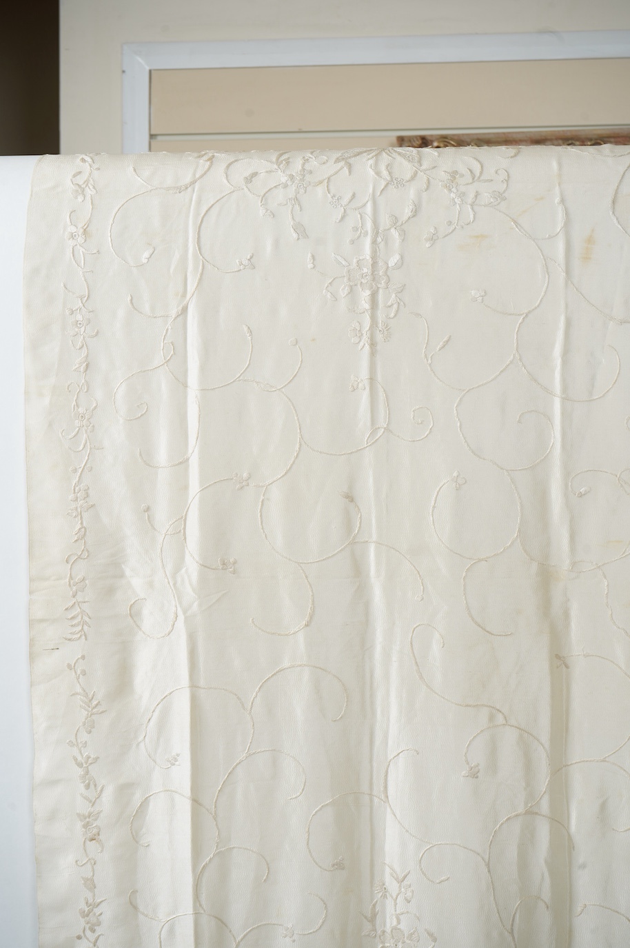 An early 20th century Chinese cream on cream silk embroidered, fringed stole, 65cm wide. Condition - some light staining.